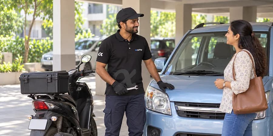 A Rotto mechanic in the black uniform greeting a customer beside her car and his scooter
